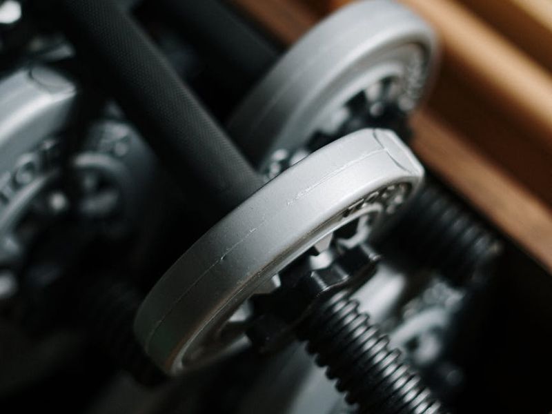 Detailed shot of fitness equipment in a neon-lit gym.