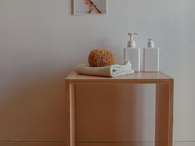 Water bottle and towel on a dark wooden floor.